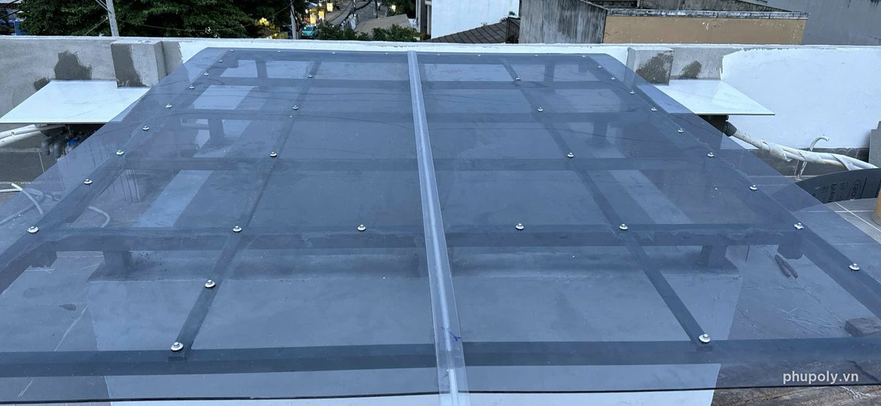 Mái che sân thượng nhà dân lợp poly đặc SolLight khói 5mm, nhìn gần nẹp và vít